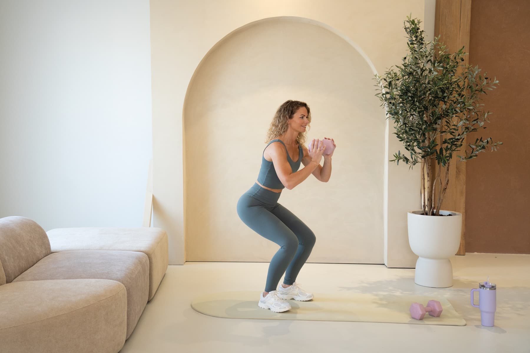 Marlou doet een squat in de studio met de boognis